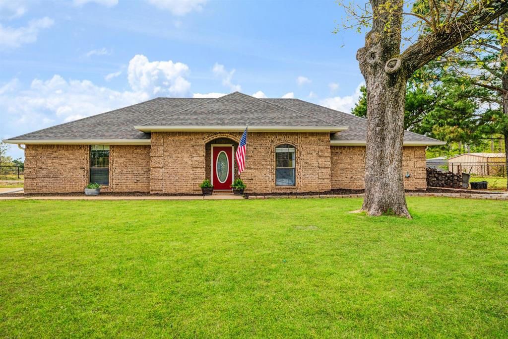a front view of house with yard and porch