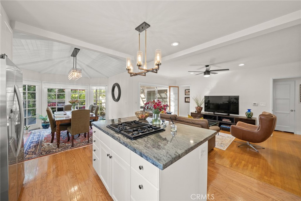 a kitchen with stainless steel appliances granite countertop a stove and a table
