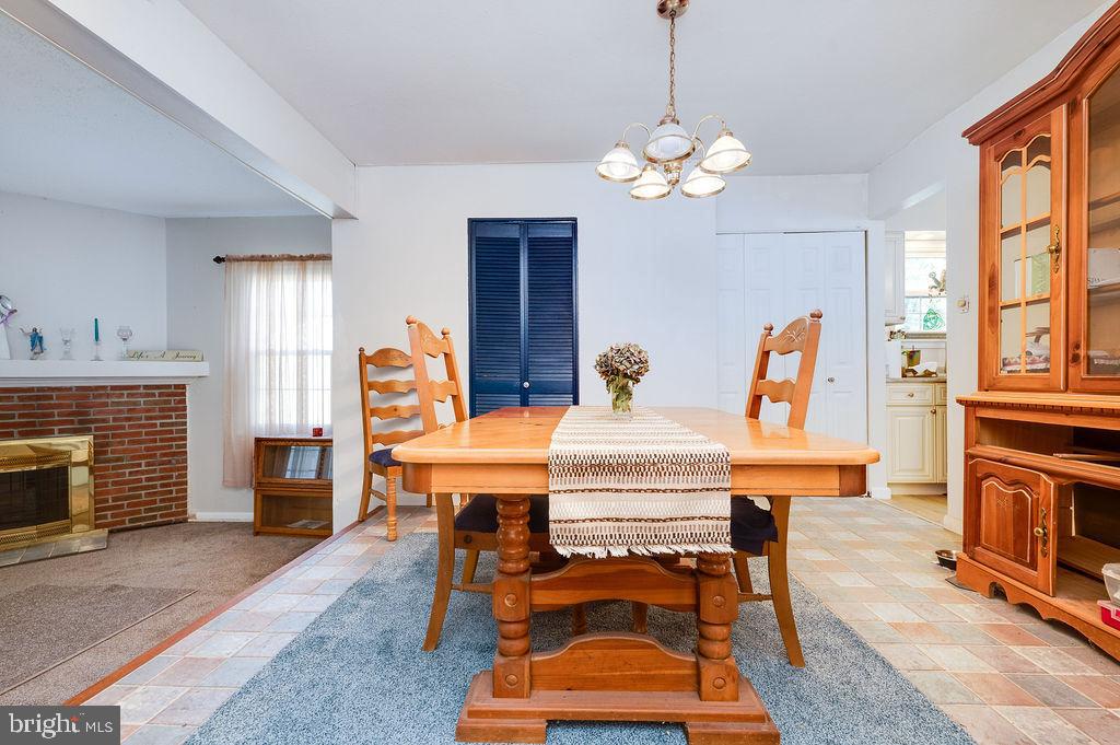 1261 Fox Run Reading, PA 19606 - Photo 15 of 46 a dining room with a table chairs and a chandelier