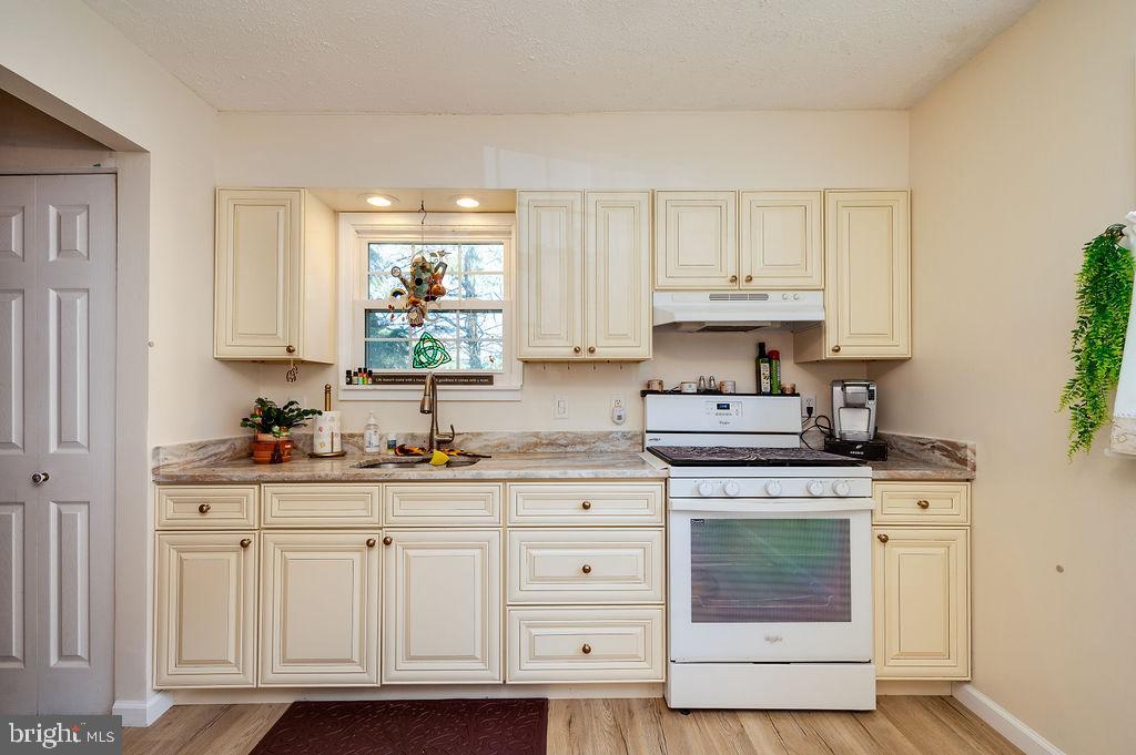 1261 Fox Run Reading, PA 19606 - Photo 6 of 46 a kitchen with granite countertop white cabinets and white appliances