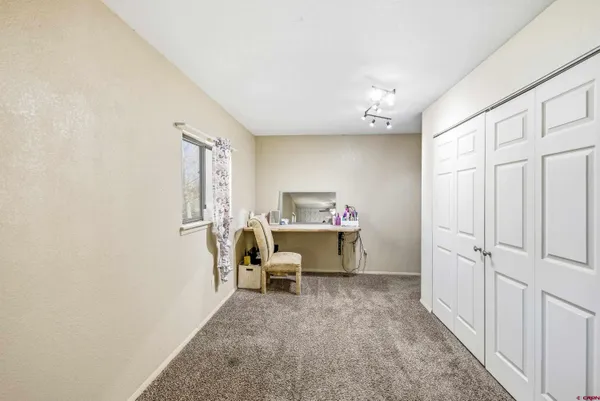 a bathroom with a granite countertop toilet sink and mirror