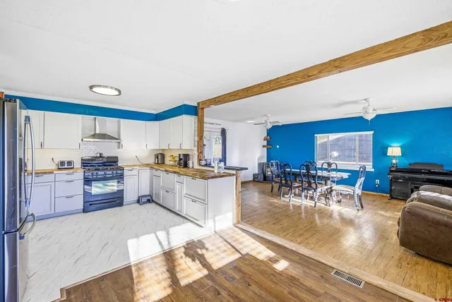 a large kitchen with lots of counter space and furniture