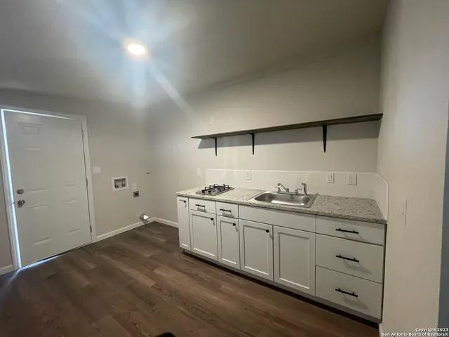 a spacious bathroom with a granite countertop sink and a mirror