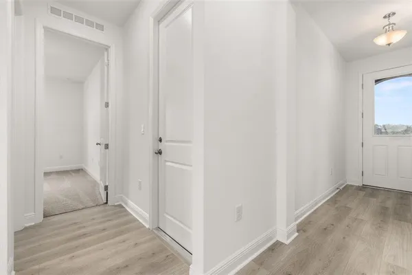 a view of a room with wooden floor and closet