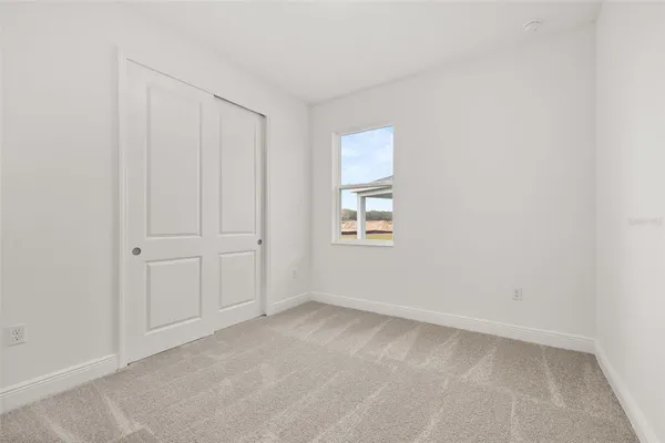 a view of an empty room and a window