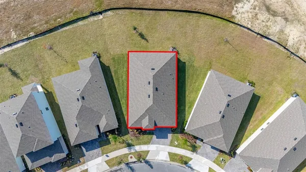 an aerial view of a house with a yard and staircase