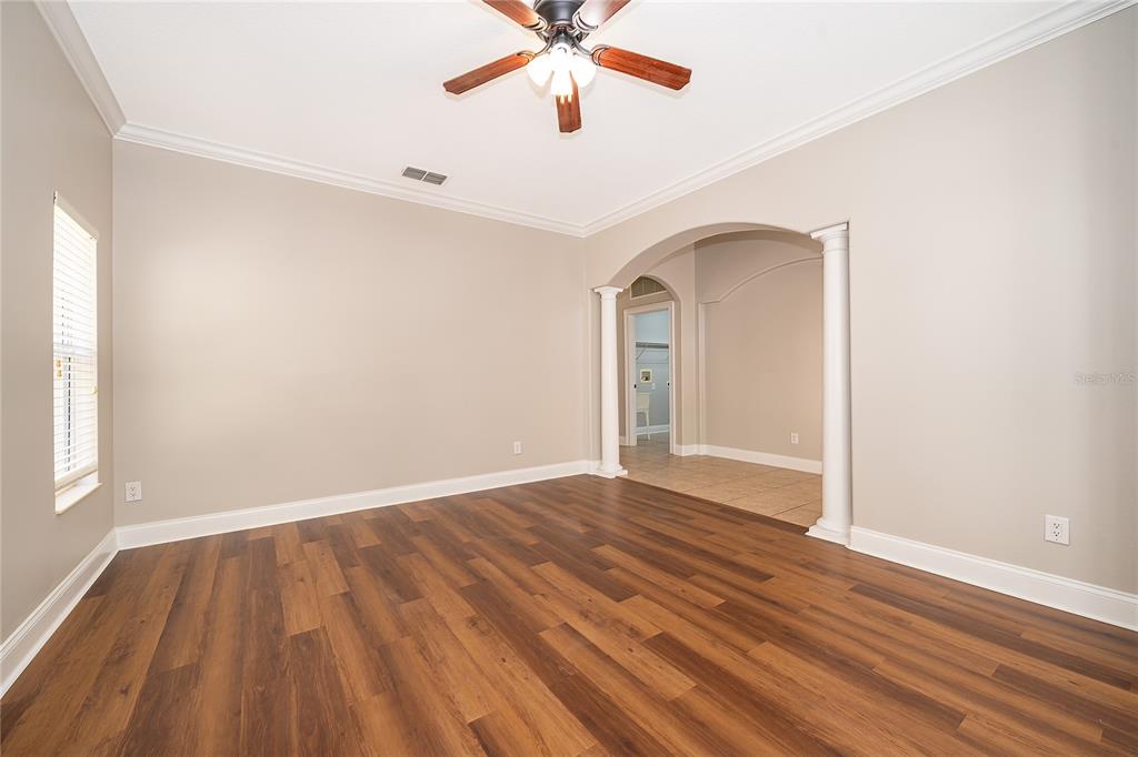 6825 Dolce Way Orlando, FL 32819 - Photo 12 of 40 a view of an empty room with window and wooden floor