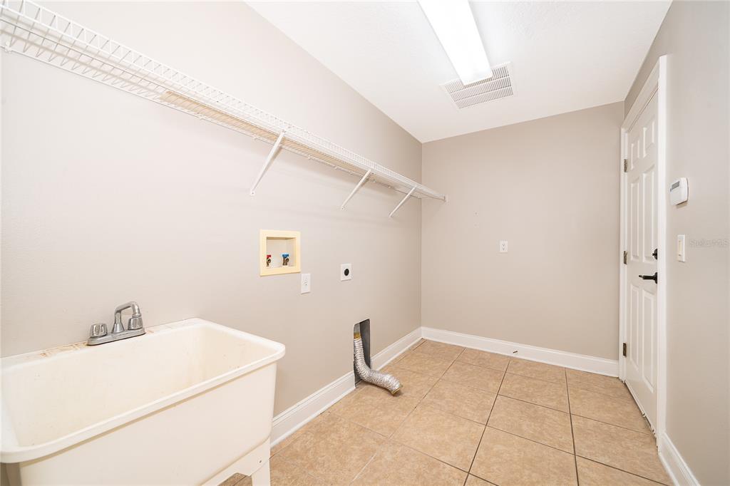 6825 Dolce Way Orlando, FL 32819 - Photo 13 of 40 a room with a sink and cabinets