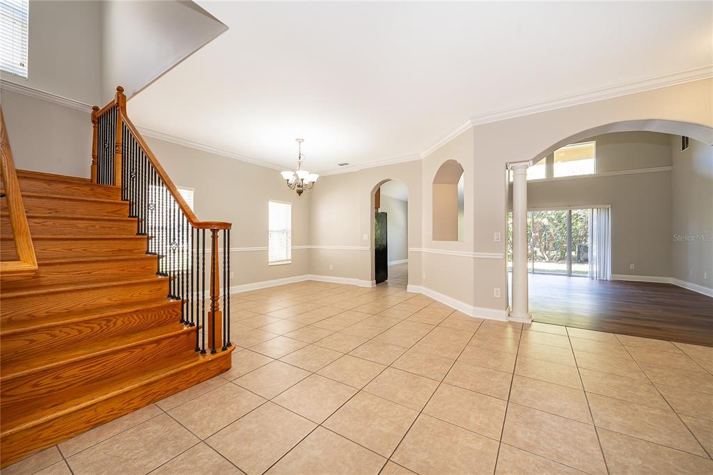 6825 Dolce Way Orlando, FL 32819 - Photo 14 of 40 a view of an entryway with wooden floor and a view of a living room