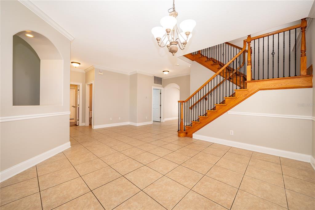 6825 Dolce Way Orlando, FL 32819 - Photo 16 of 40 a view of entryway and hall with a chandelier