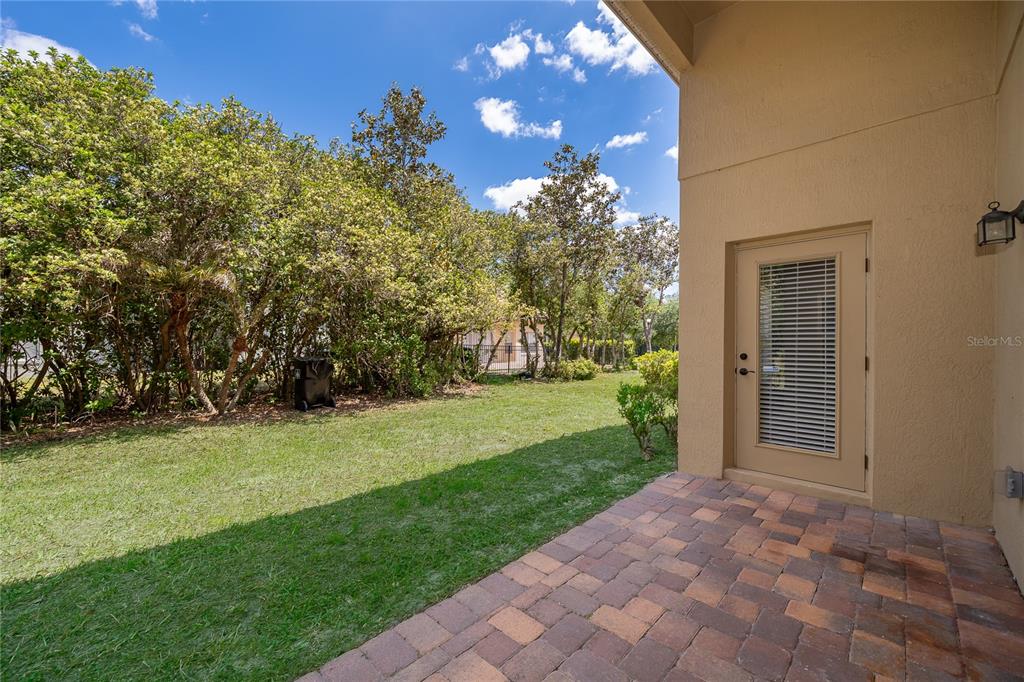 6825 Dolce Way Orlando, FL 32819 - Photo 25 of 40 a view of a backyard with large trees