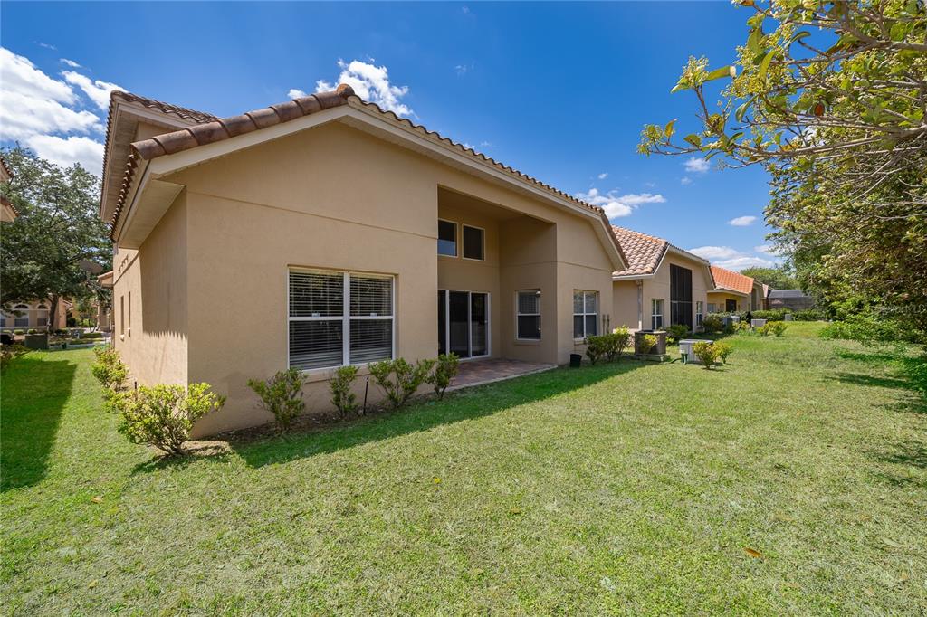 6825 Dolce Way Orlando, FL 32819 - Photo 26 of 40 a front view of a house with garden