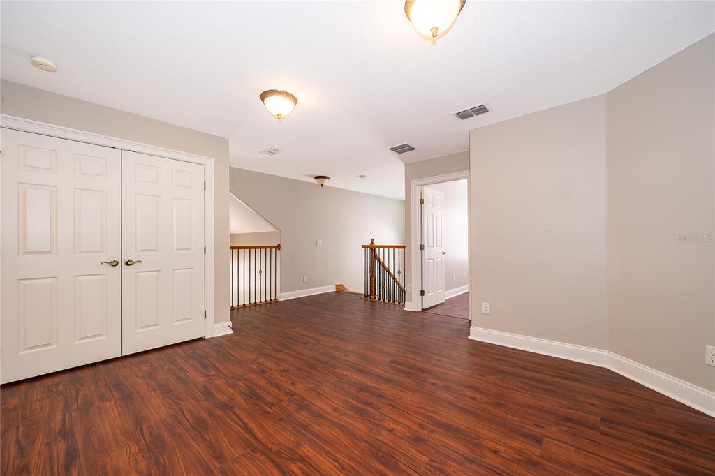 6825 Dolce Way Orlando, FL 32819 - Photo 33 of 40 a view of empty room with wooden floor