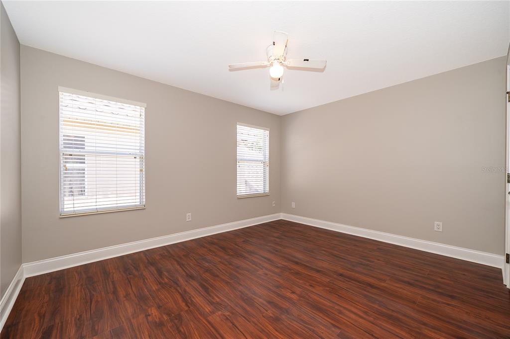 6825 Dolce Way Orlando, FL 32819 - Photo 34 of 40 a view of an empty room with wooden floor and a window