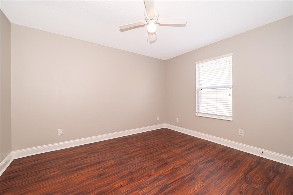 6825 Dolce Way Orlando, FL 32819 - Photo 35 of 40 wooden floor in an empty room with a window