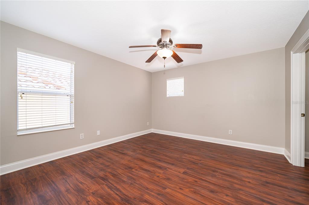 6825 Dolce Way Orlando, FL 32819 - Photo 38 of 40 an empty room with wooden floor fan and windows