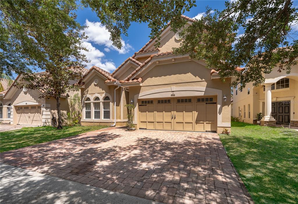 6825 Dolce Way Orlando, FL 32819 - Photo 6 of 40 a front view of a house with a garden