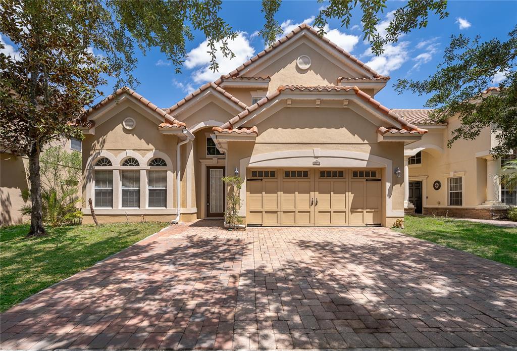 6825 Dolce Way Orlando, FL 32819 - Photo 7 of 40 a front view of a house with a yard
