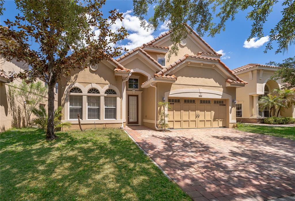 6825 Dolce Way Orlando, FL 32819 - Photo 8 of 40 a front view of a house with a yard