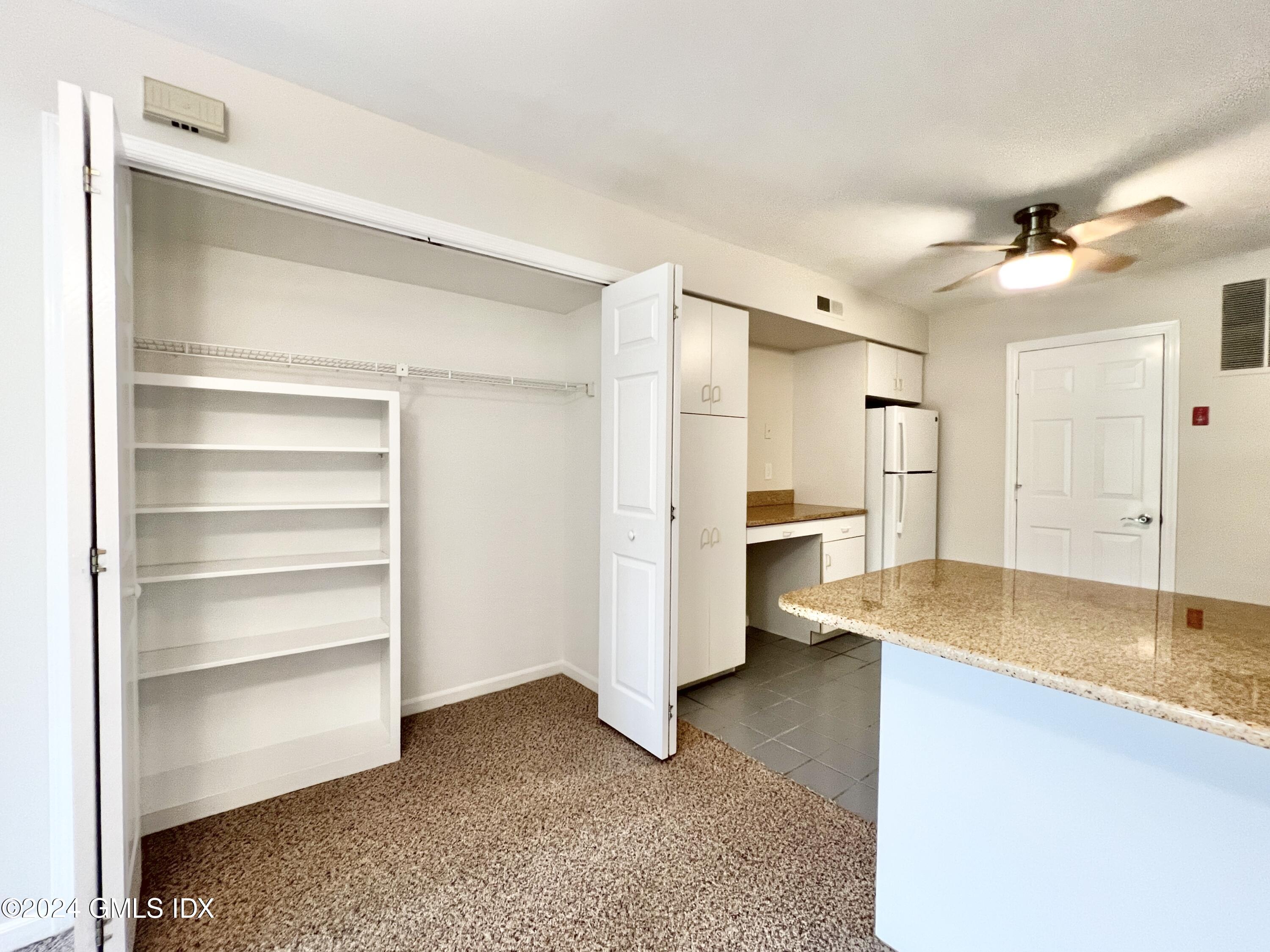 351 Pemberwick Road, Unit 206 Greenwich, CT 06831 - Photo 12 of 25 a view of a kitchen with a sink and a refrigerator