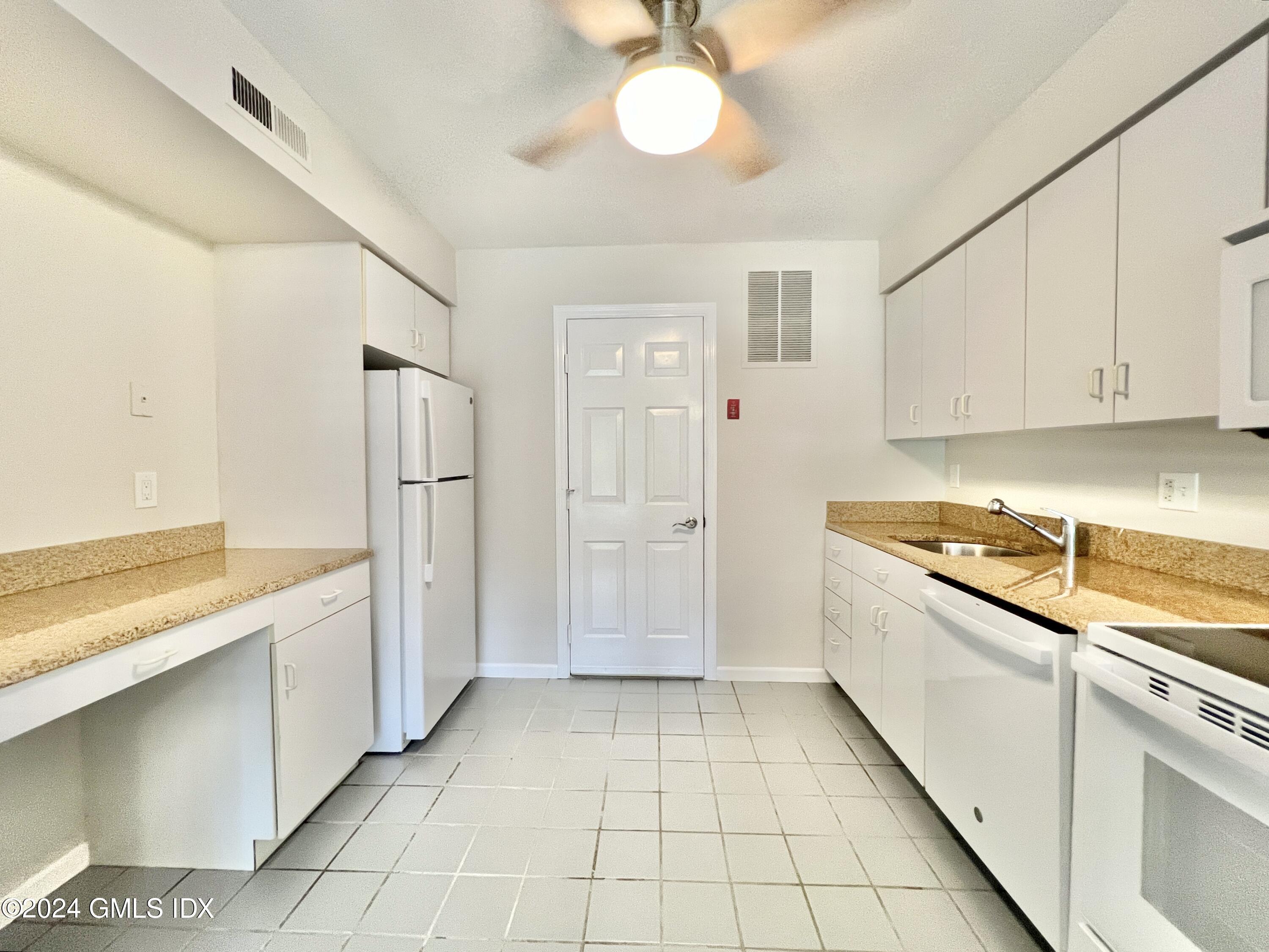 351 Pemberwick Road, Unit 206 Greenwich, CT 06831 - Photo 14 of 25 a kitchen with a refrigerator a stove and cabinets