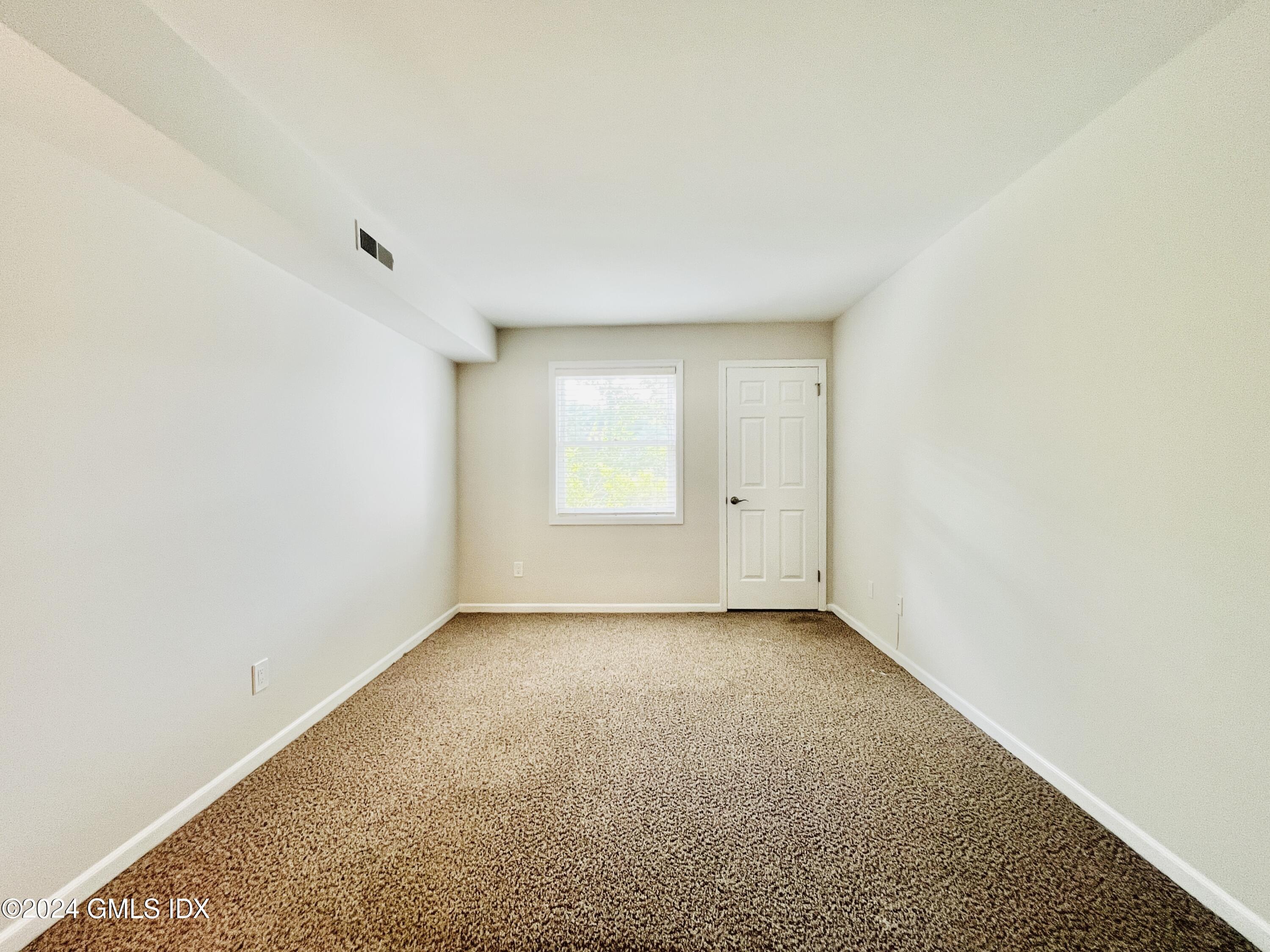 351 Pemberwick Road, Unit 206 Greenwich, CT 06831 - Photo 20 of 25 a view of an empty room with a window