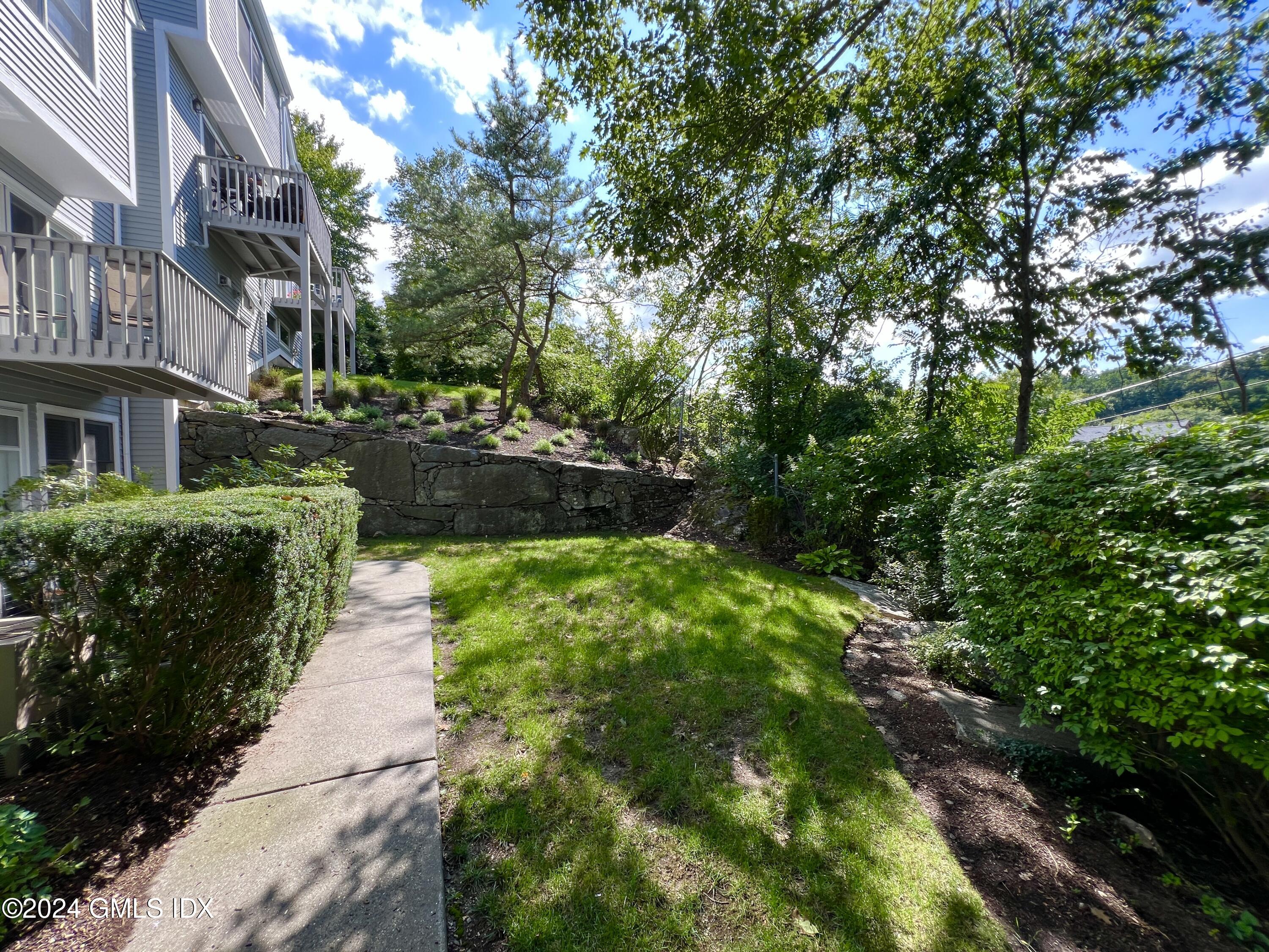 351 Pemberwick Road, Unit 206 Greenwich, CT 06831 - Photo 3 of 25 a view of a garden with pathway