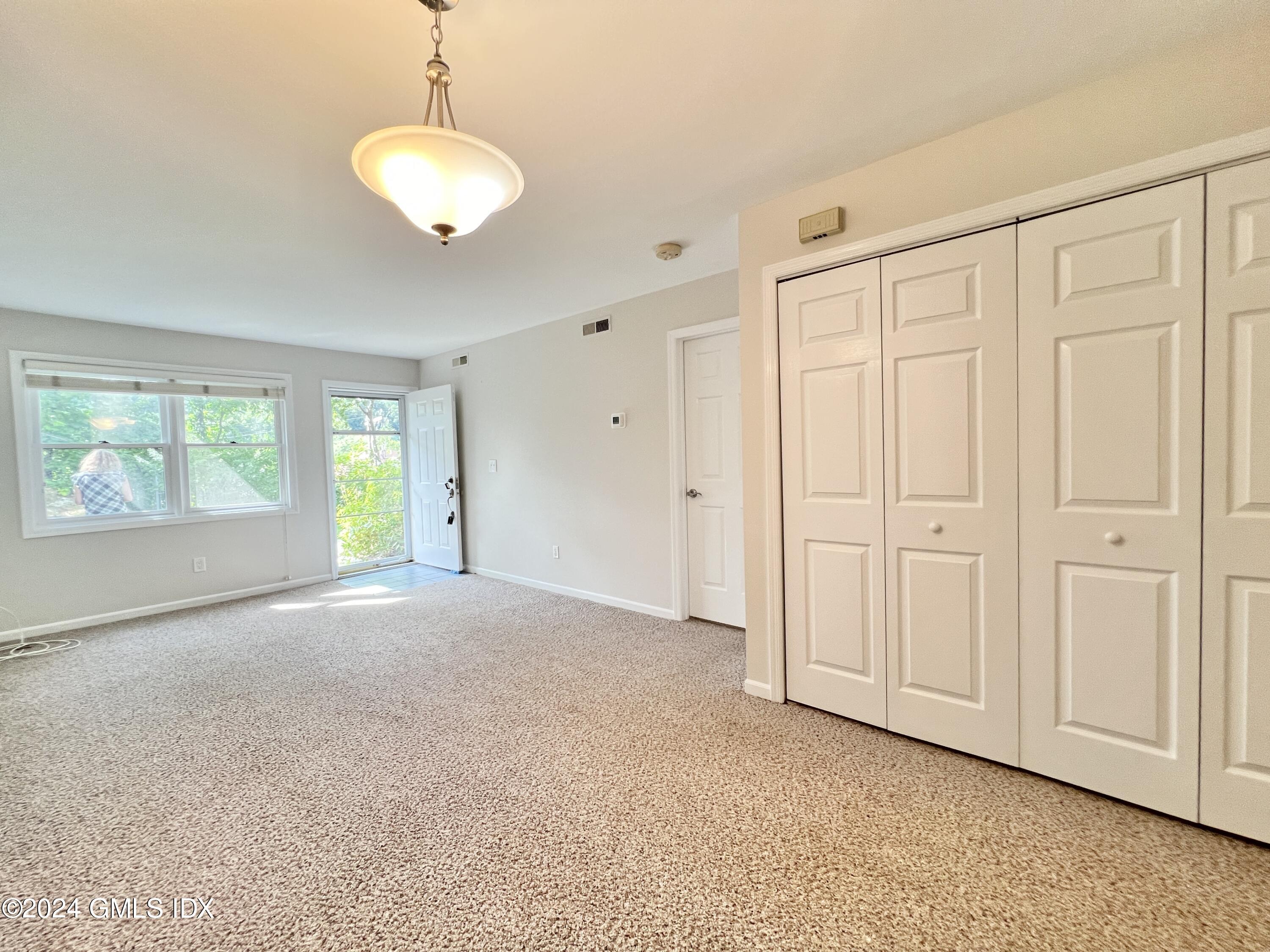 351 Pemberwick Road, Unit 206 Greenwich, CT 06831 - Photo 6 of 25 an empty room with windows