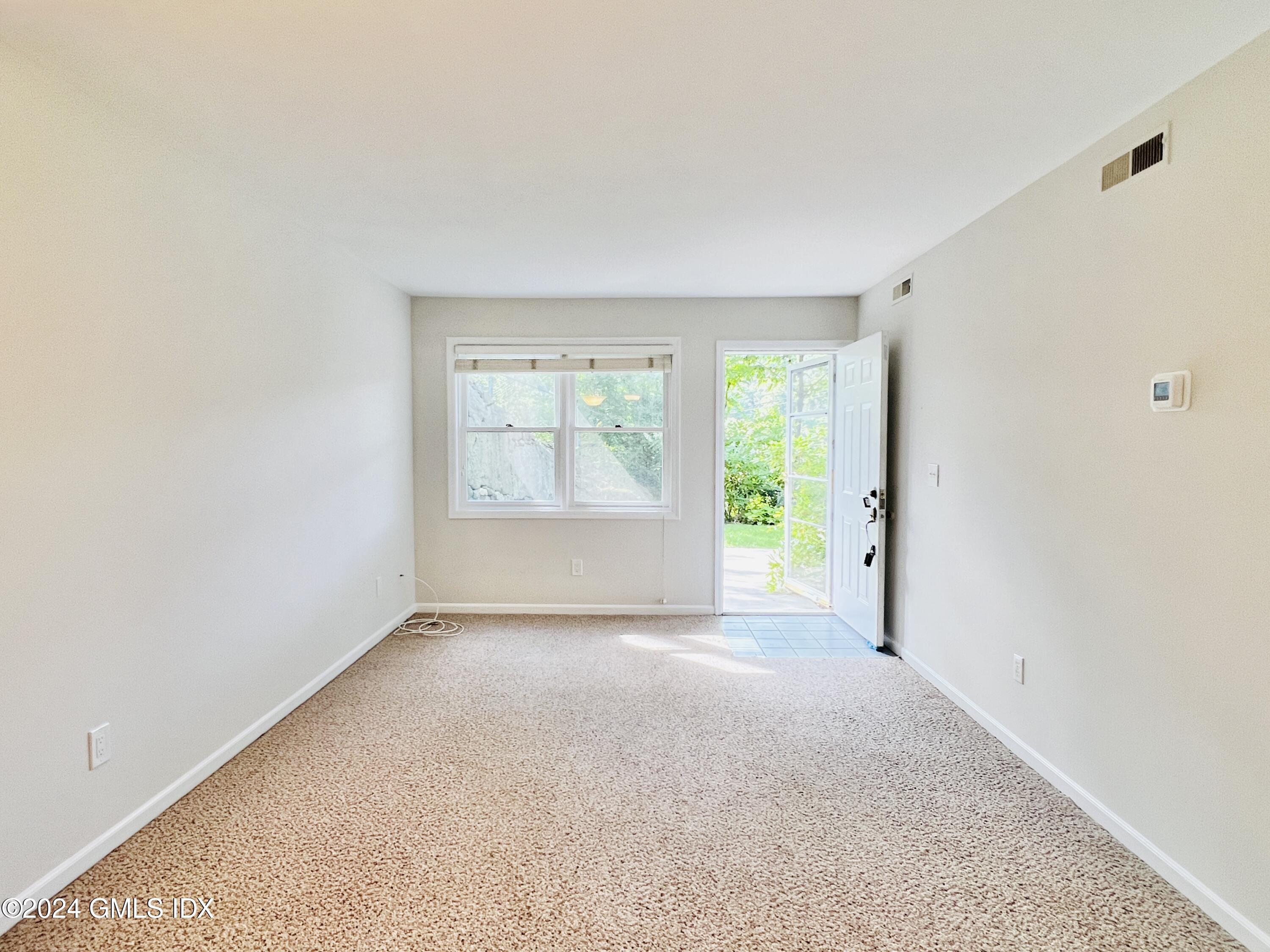 351 Pemberwick Road, Unit 206 Greenwich, CT 06831 - Photo 9 of 25 an empty room with windows