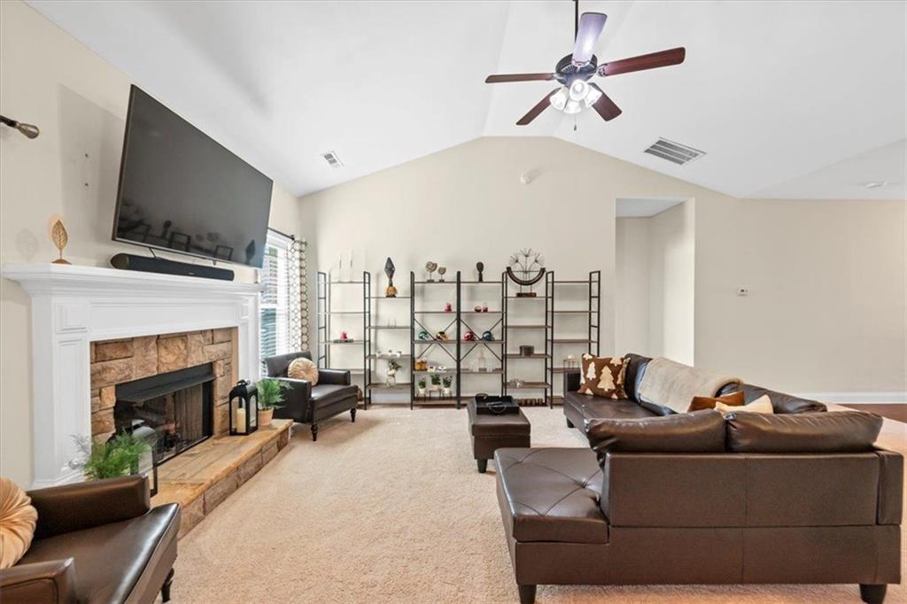 229 Summer Gate Lane Villa Rica, GA 30180 - Photo 13 of 28 a living room with furniture a fireplace and a flat screen tv