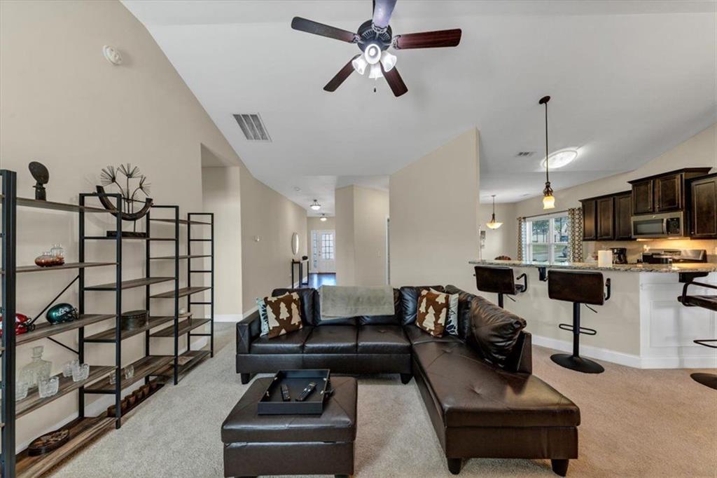 229 Summer Gate Lane Villa Rica, GA 30180 - Photo 14 of 28 a living room with furniture gym equipment and a view of kitchen