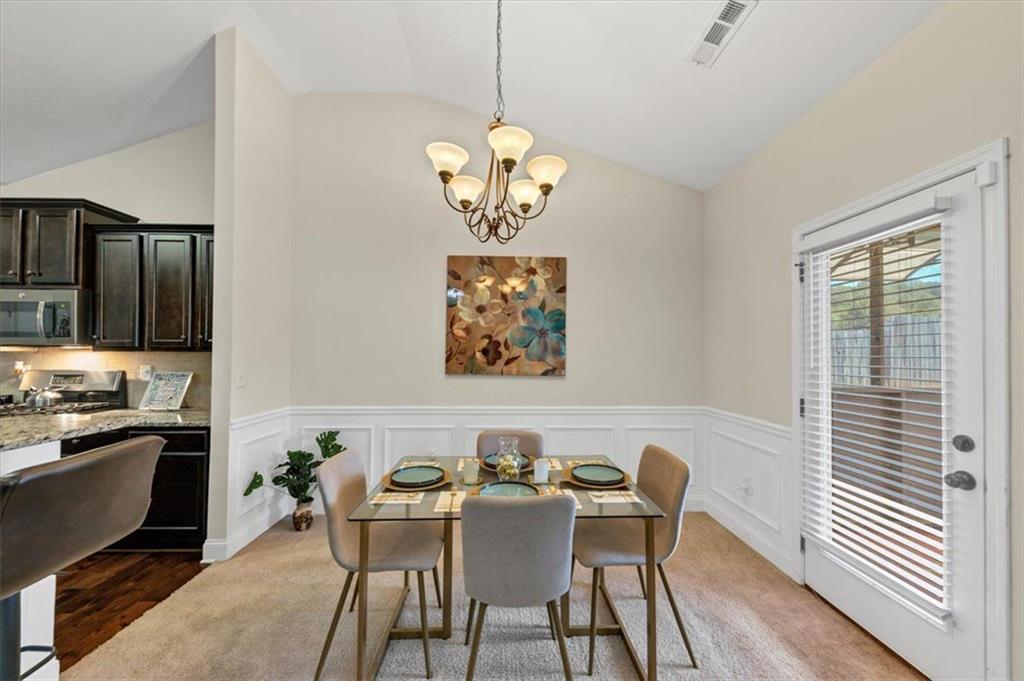 229 Summer Gate Lane Villa Rica, GA 30180 - Photo 15 of 28 a view of a dining room with furniture wooden floor and a chandelier