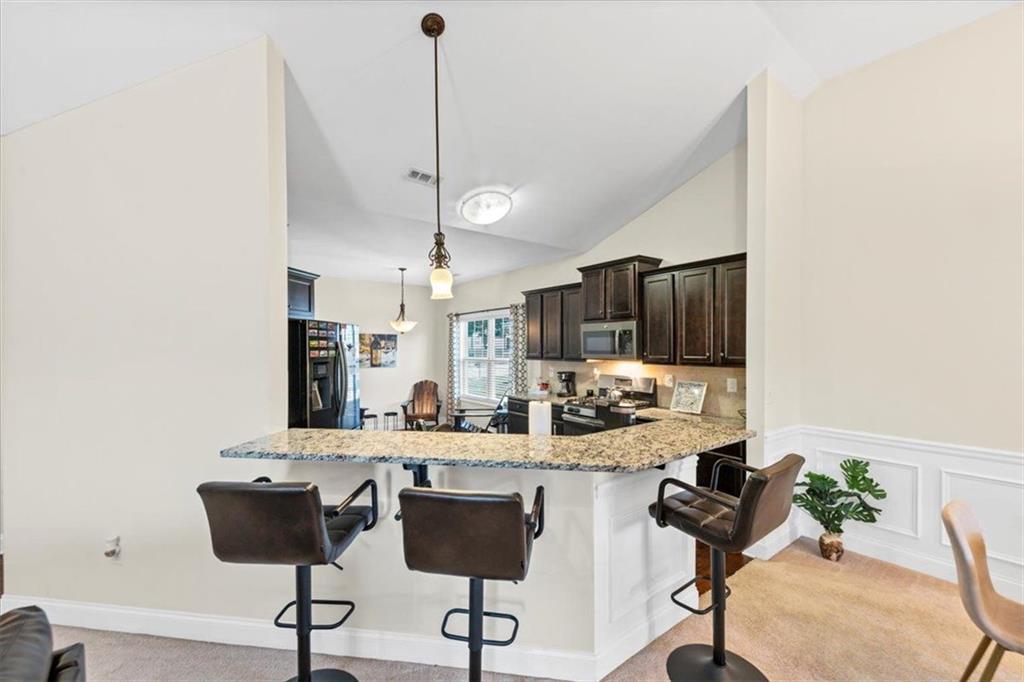 229 Summer Gate Lane Villa Rica, GA 30180 - Photo 16 of 28 a view of a kitchen and dining room