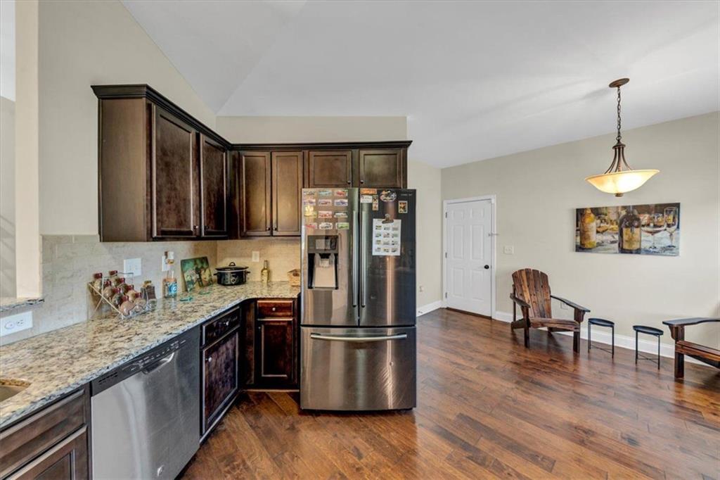 229 Summer Gate Lane Villa Rica, GA 30180 - Photo 18 of 28 a kitchen with stainless steel appliances granite countertop a refrigerator stove top oven and sink