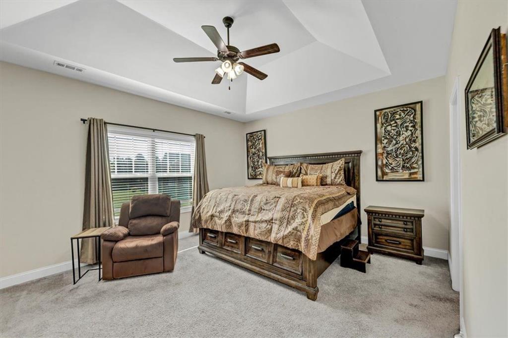 229 Summer Gate Lane Villa Rica, GA 30180 - Photo 20 of 28 a spacious bedroom with a bed and glass window