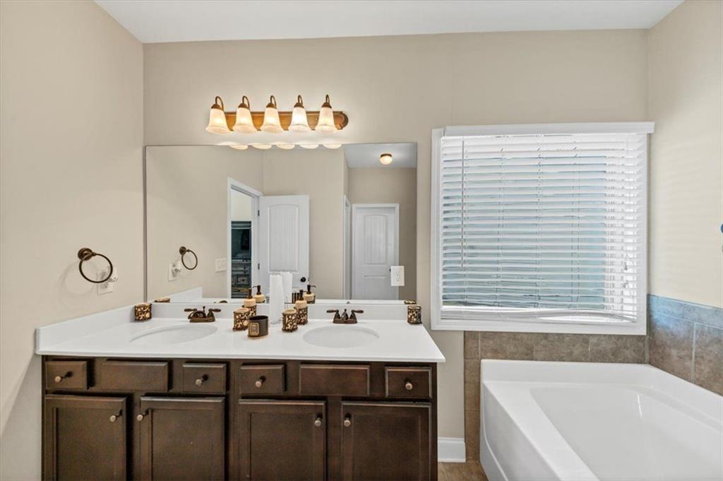229 Summer Gate Lane Villa Rica, GA 30180 - Photo 22 of 28 a bathroom with a sink and a bathtub