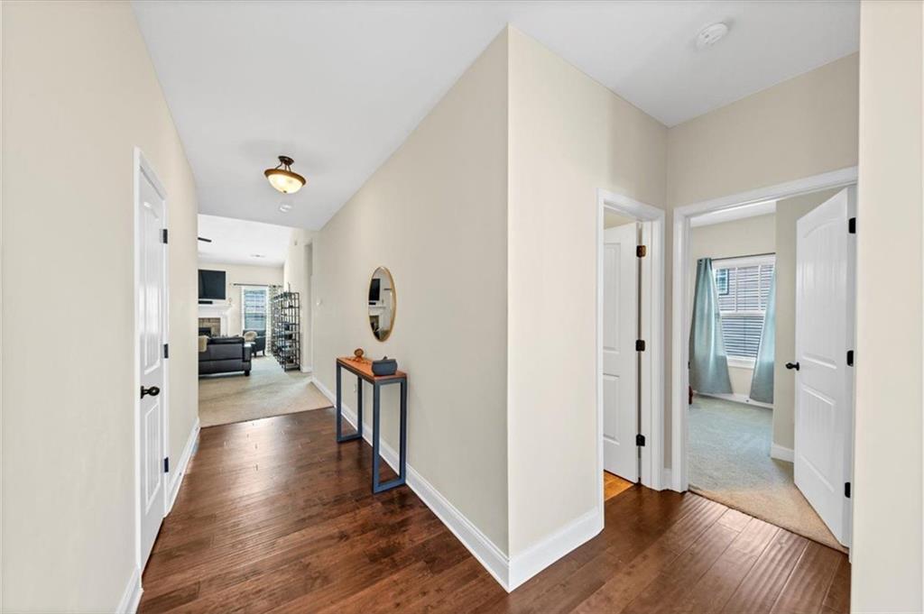 229 Summer Gate Lane Villa Rica, GA 30180 - Photo 6 of 28 a view of a hallway with wooden floor and a living room