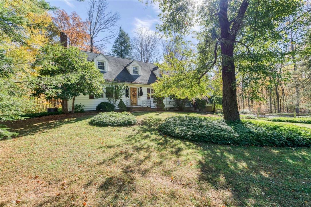 a view of a house with a yard and tree s