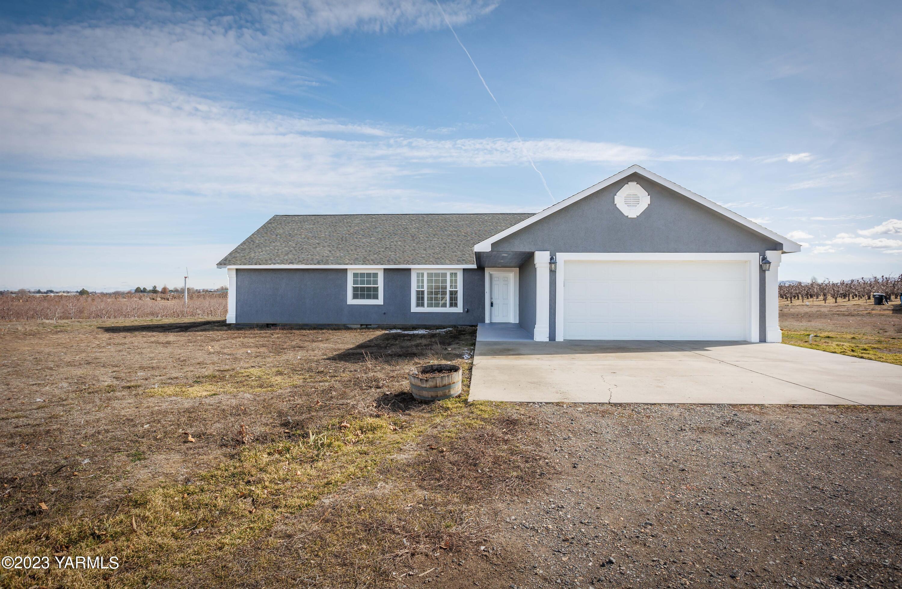 361 Puterbaugh Road Grandview, WA 98930 - Photo 1 of 47 a front view of a house with a yard