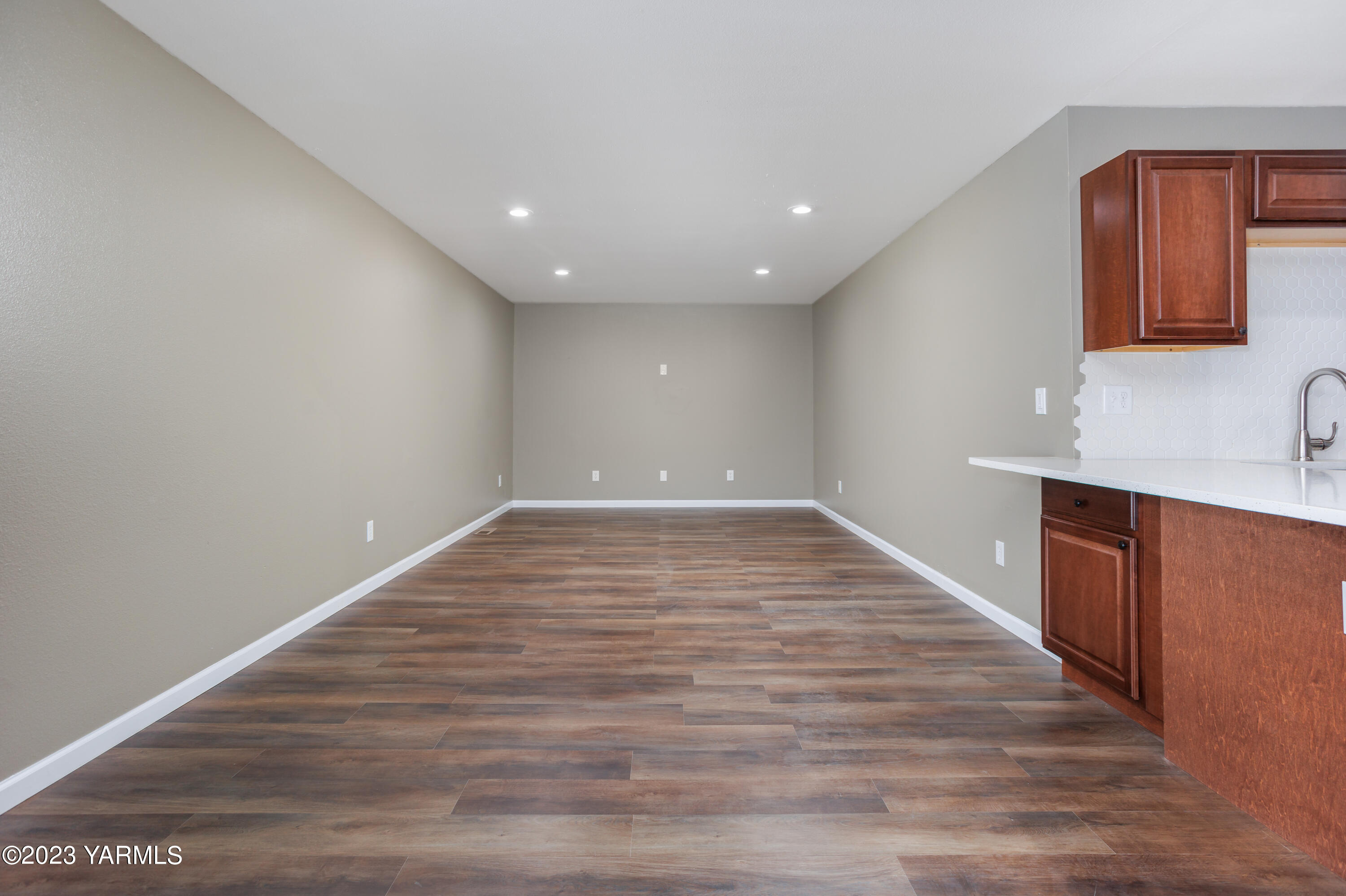 361 Puterbaugh Road Grandview, WA 98930 - Photo 12 of 47 a view of an empty room with wooden floor and a window