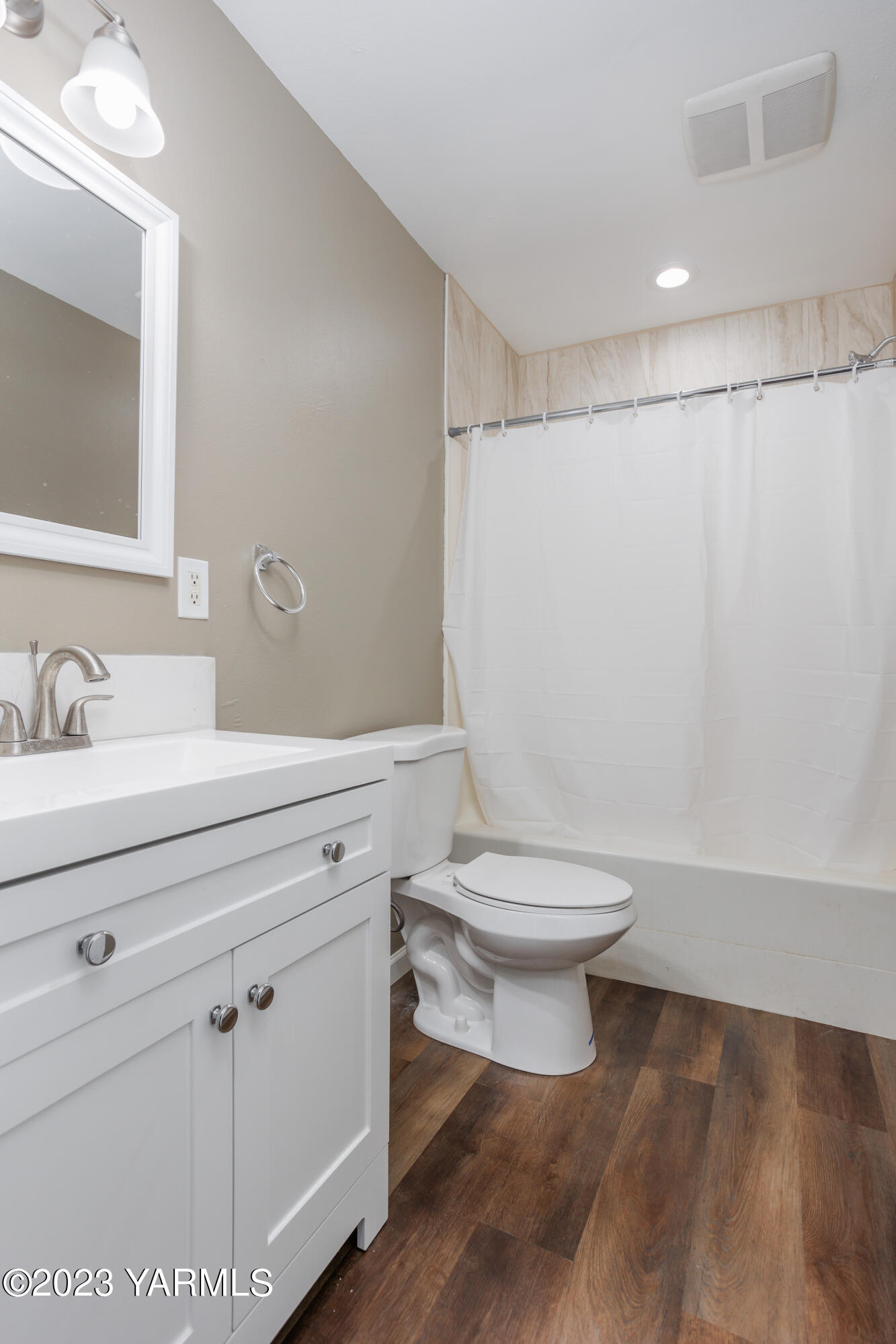361 Puterbaugh Road Grandview, WA 98930 - Photo 18 of 47 a bathroom with a toilet sink a mirror and vanity