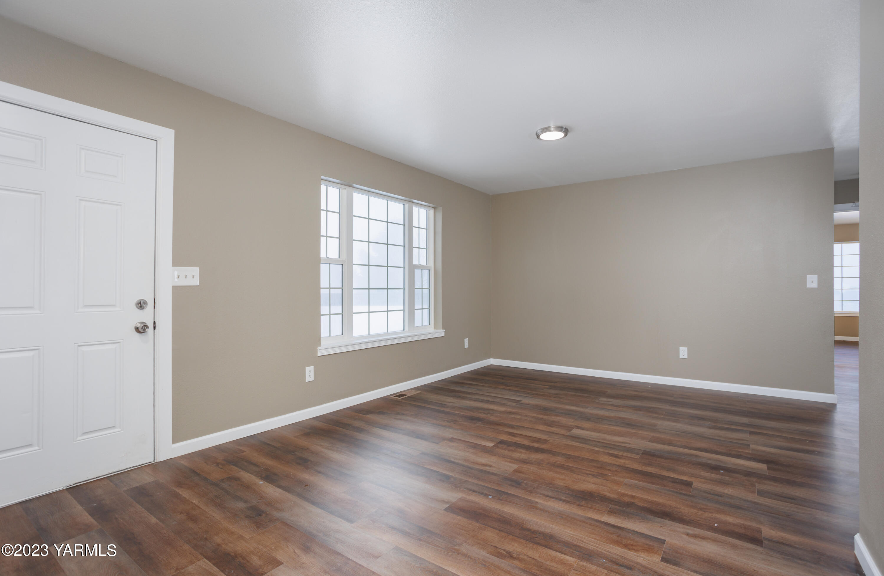 361 Puterbaugh Road Grandview, WA 98930 - Photo 25 of 47 a view of an empty room with wooden floor and a window