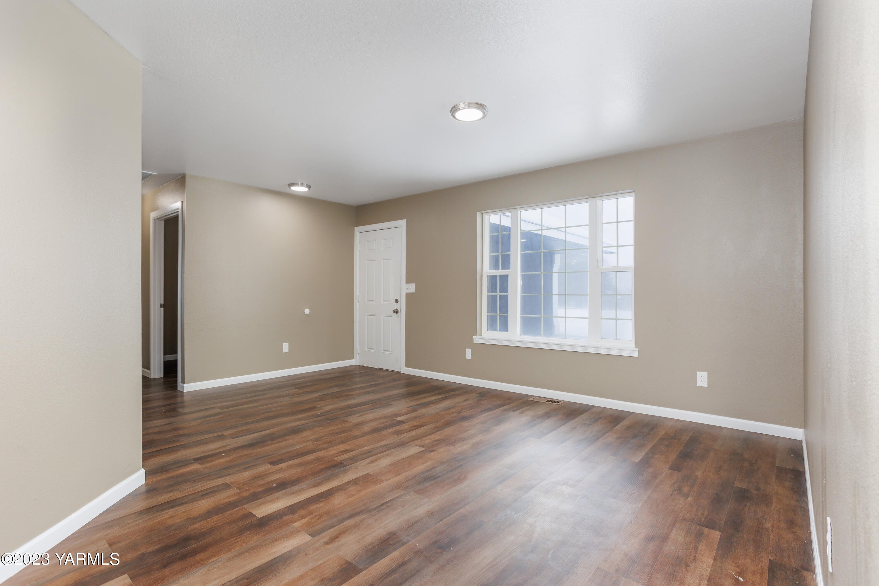 361 Puterbaugh Road Grandview, WA 98930 - Photo 27 of 47 a view of an empty room with wooden floor and a window