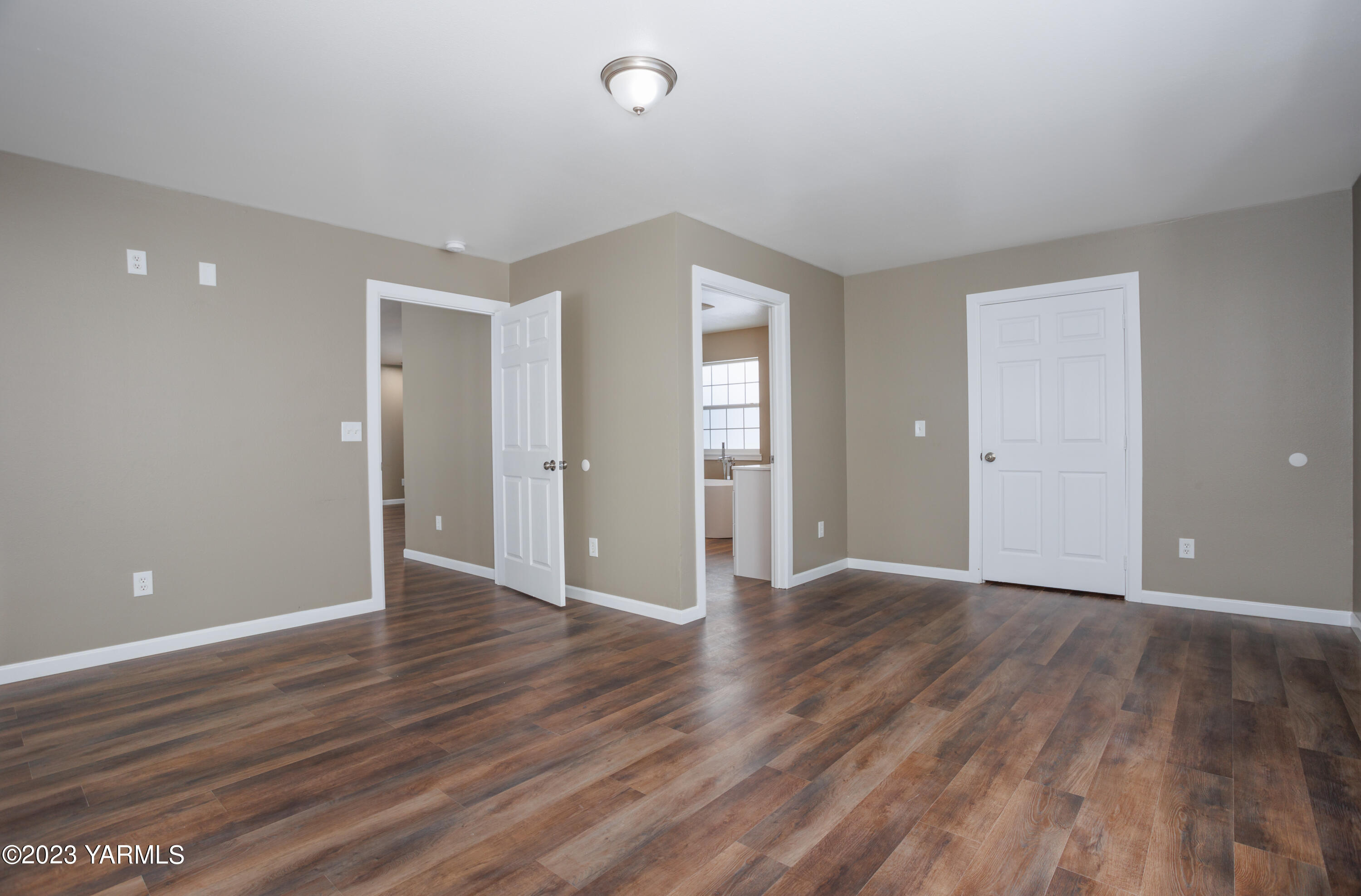 361 Puterbaugh Road Grandview, WA 98930 - Photo 28 of 47 a view of an empty room with wooden floor and closet