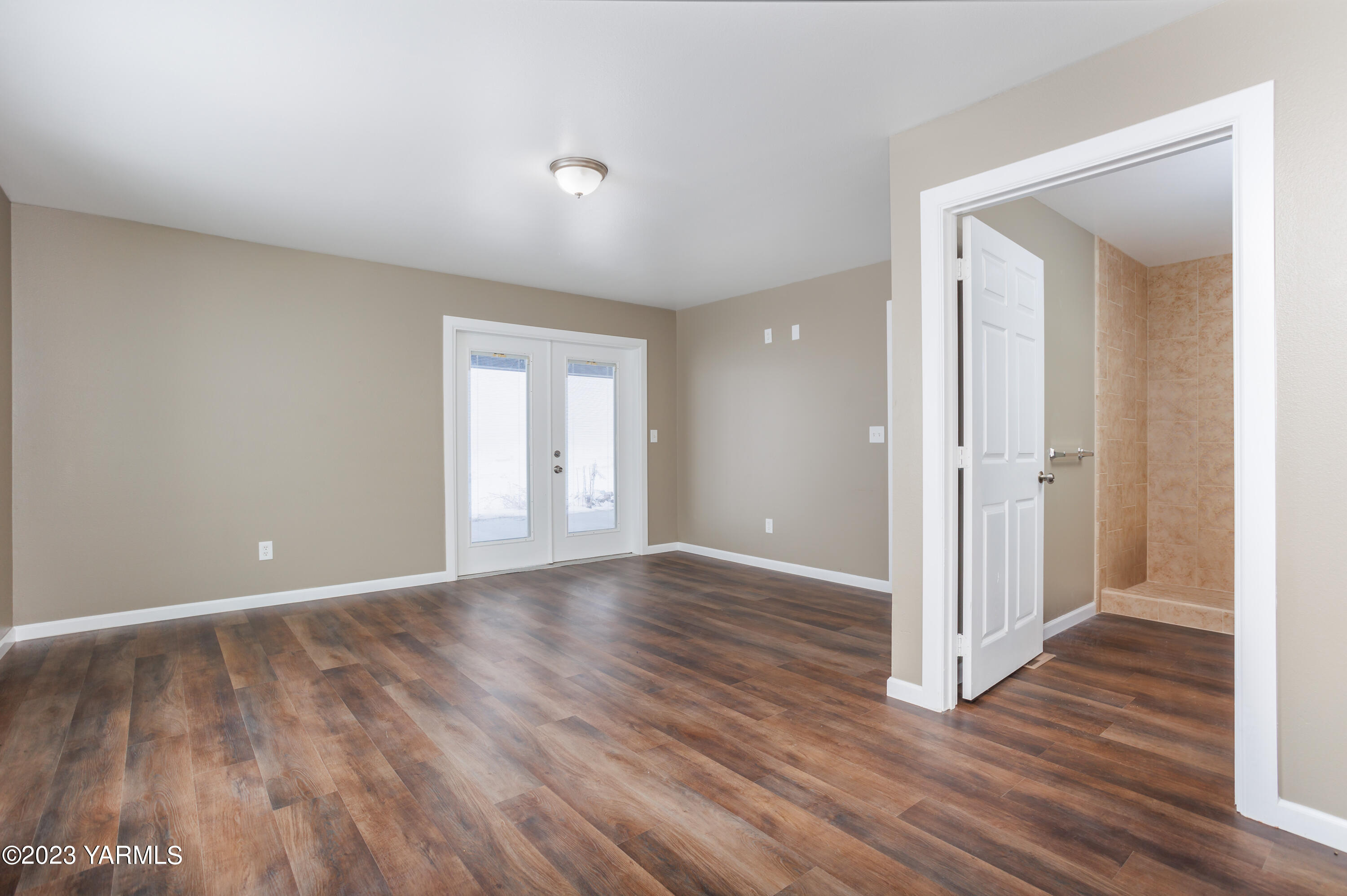 361 Puterbaugh Road Grandview, WA 98930 - Photo 29 of 47 a view of an empty room with wooden floor and a window