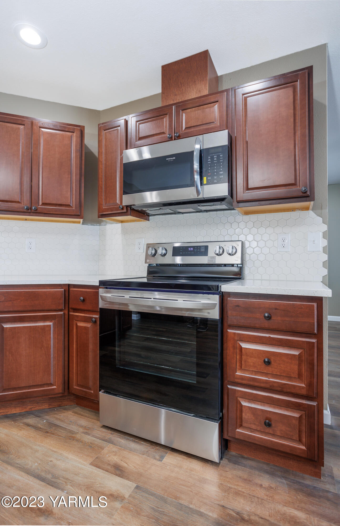 361 Puterbaugh Road Grandview, WA 98930 - Photo 6 of 47 a kitchen with stainless steel appliances granite countertop a stove and a microwave