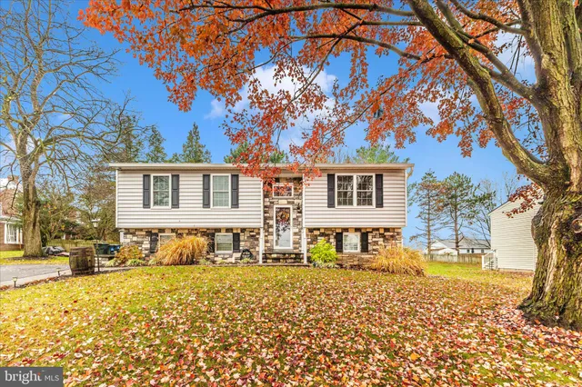 a front view of a house with a yard covered with snow