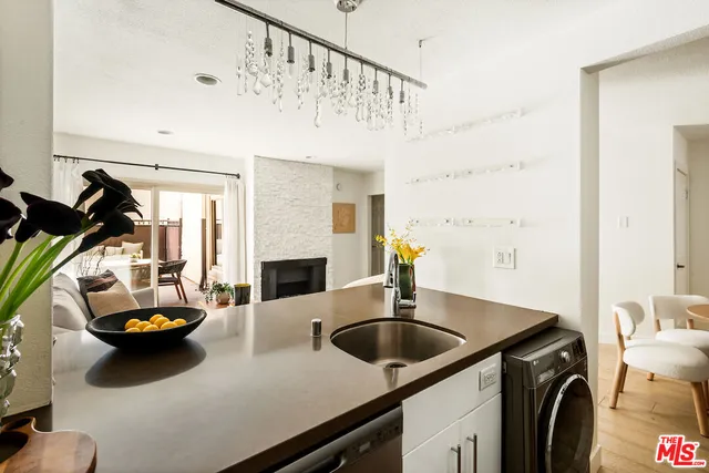 a kitchen with sink a faucet and chairs