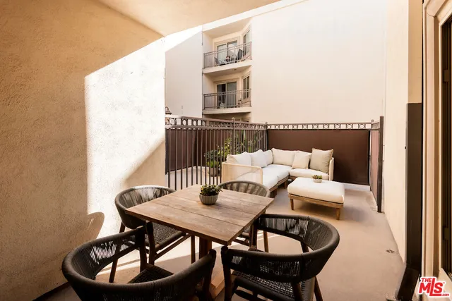 a balcony view with a table and chairs