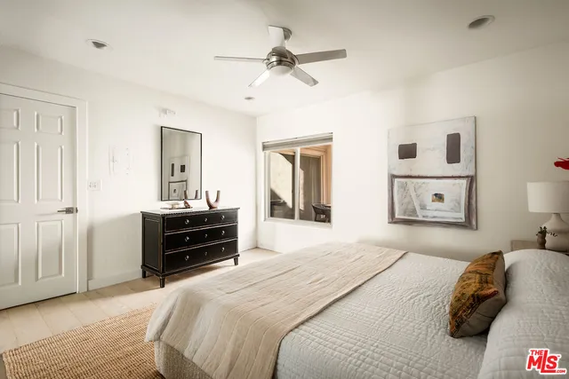 a bedroom with a bed and a mirror